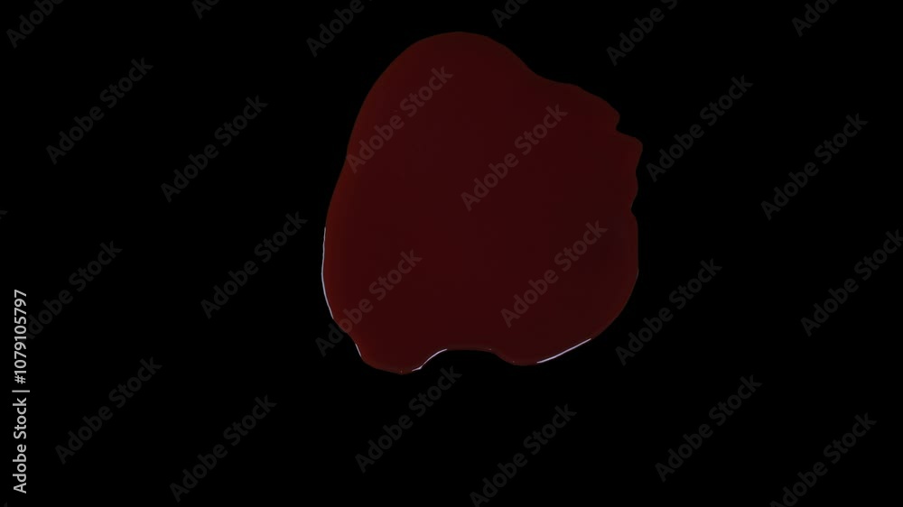 Drop of blood expanding on black background Drop of blood expanding on black background