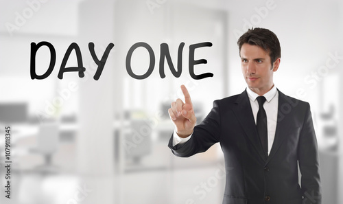 Businessman touching "Day one" text on transparent wipe board in an office