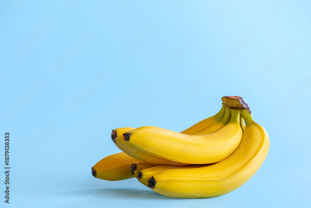 Side view of Bunch of isolated bananas on a colored background. Bananas on a blue aqua background with copy space. Fresh Fruit healthy food for marketing Side view of Bunch of isolated bananas on a colored background. Bananas on a blue aqua background with copy space. Fresh Fruit healthy food for marketing
