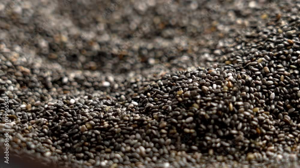 Close up of a hand gently taking a handful of chia seeds Close up of a hand gently taking a handful of chia seeds