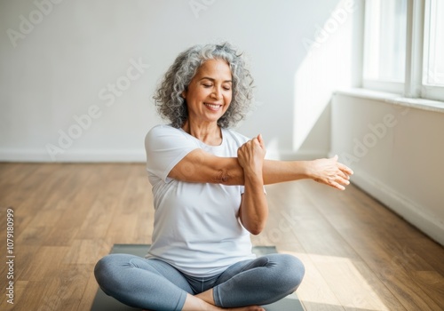 Senior woman practicing yoga in a sunlit room for healthy aging and flexibility