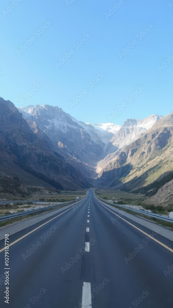 Empty highway cutting through beautiful mountain landscape under clear blue sky, horizon, scenic drive Empty highway cutting through beautiful mountain landscape under clear blue sky, horizon, scenic drive