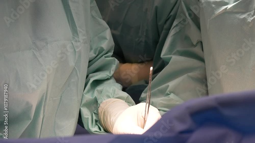 Doctors surgeons perform surgery in the operating room.