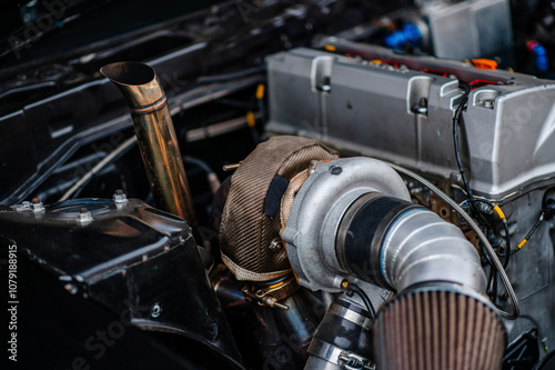 Heat shield from a very hot turbo.The heat shield prevents the engine from accumulating high heat.The big turbo is in the gasoline engine.Large turbos are put on drift cars. photo