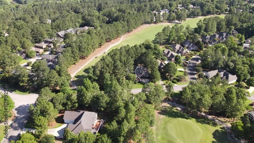 Suburban neighborhood captured by drone in California, USA, showing green lawns, residential houses, and tree-filled surroundings, highlighting a peaceful, scenic community landscape