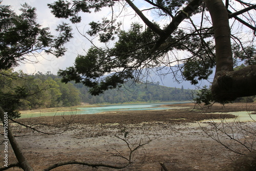 Telaga Warna, tourist destination lake in Dieng, where the water often recedes during the long dry season. photo