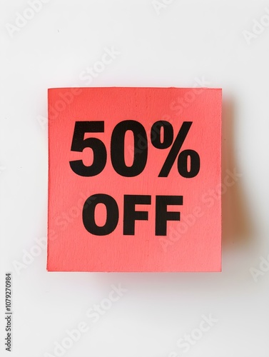 Black '50% OFF' Text on a Light Red Square Paper Note. White Background 