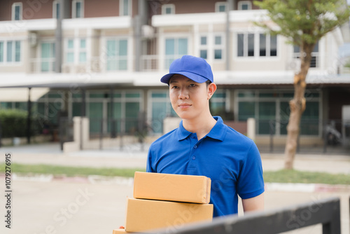 Delivery Man with Packages: A friendly delivery man in blue uniform and cap, holding a stack of cardboard boxes, stands confidently in front of a residential home, ready to deliver packages. 