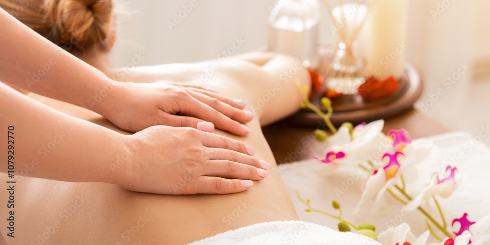Hands of masseur on back of girl during massage Hands of masseur on back of girl during massage
