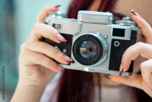 The camera in the hands of a young girl, aesthetic, photography concept