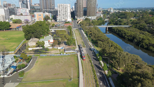Aerial drone view of a light rail vehicle at Parramatta cbd in Western Sydney, NSW, Australia as it travels along George Street in November 2024 