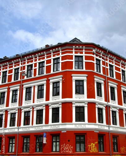 Canvas Print Red and white brick building with blue sky background in Oslo, Norway