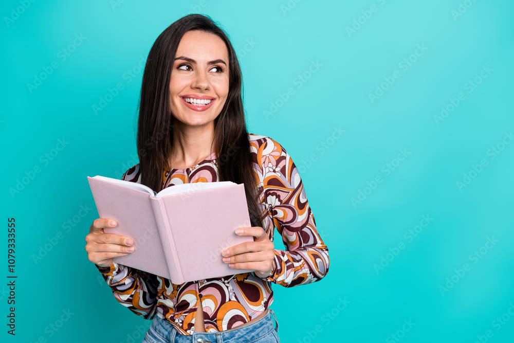 Photo of cheerful pretty lady dressed retro shirt reading interesting novel looking empty space isolated blue color background