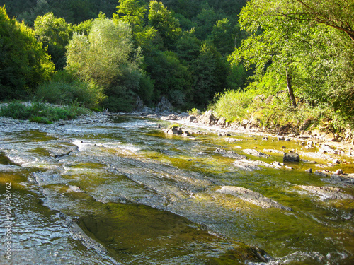 Sunny September view of the shallow waters of Vidima River at the pool called Priboy, near the village of Debnevo, Troyan Minucipality, Northern Bulgaria photo