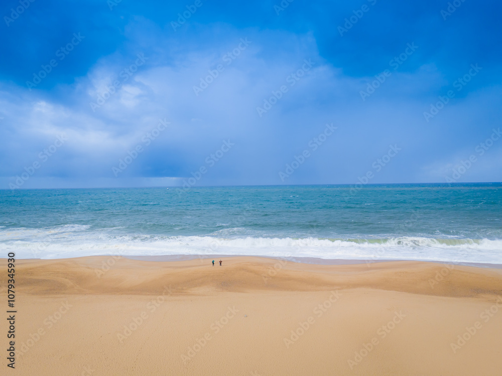Breaking waves at Nazare beach on the Portugal coastal town on the Atlantic ocean shore. Aerial drone view Breaking waves at Nazare beach on the Portugal coastal town on the Atlantic ocean shore. Aerial drone view