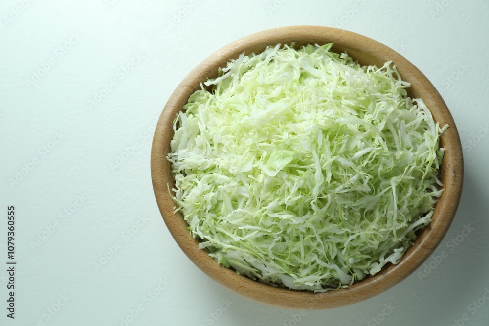 Fresh shredded cabbage on light table, top view. Space for text Fresh shredded cabbage on light table, top view. Space for text