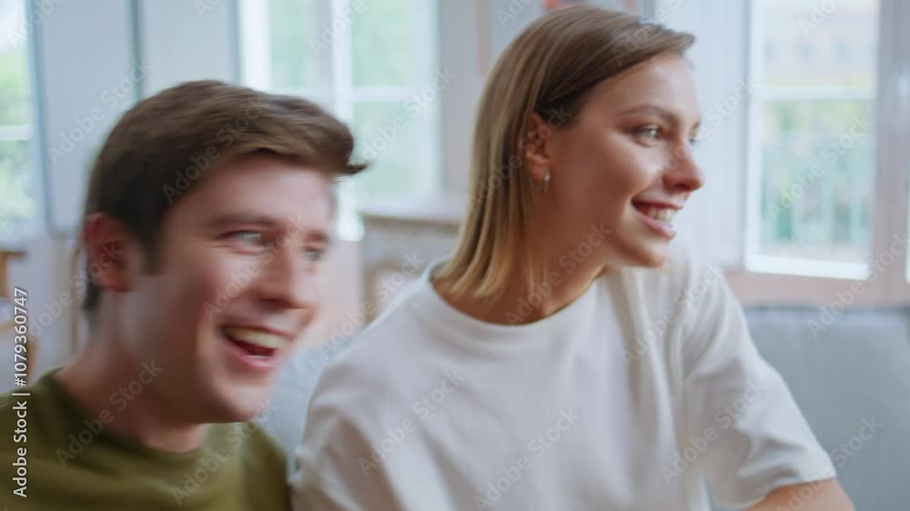 Youngsters enjoy video game laughing at home closeup. Gamers playing on consoles Youngsters enjoy video game laughing at home closeup. Gamers playing on consoles