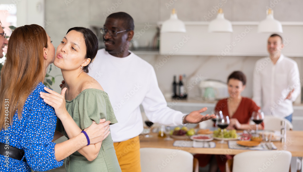 Married couples meet at home for a festive dinner. Greet each other Married couples meet at home for a festive dinner. Greet each other