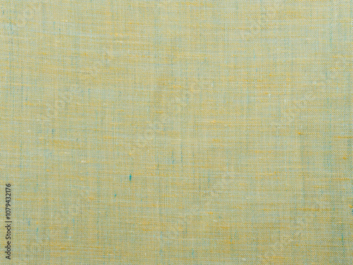 Background - new yellow-green linen fabric. High-quality texture of expensive fabric.