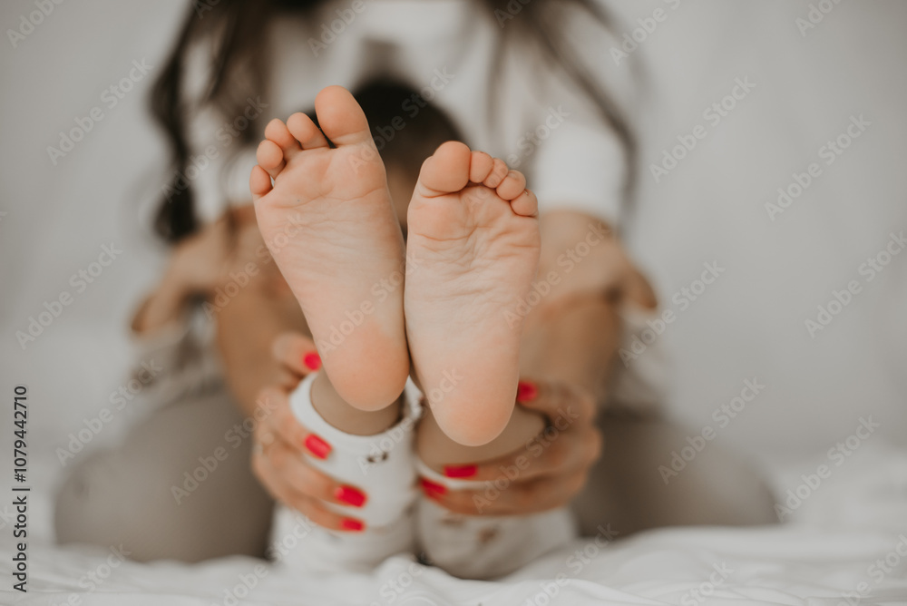 Naklejka premium Childs Feet Held by Parent