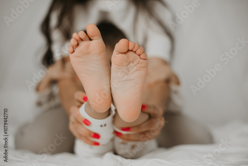 Childs Feet Held by Parent photo