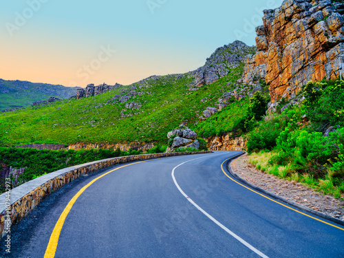 Obraz na płótnie Road winding through Langeberg Mountains to Tradouw Pass under blue sky and white clouds, Suurbraak, Overberg, Western Cape, South Africa w salonie