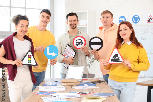 People with traffic signs a...
