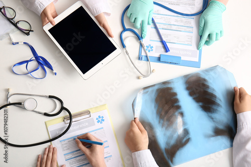 Doctor's hands with tablet,...