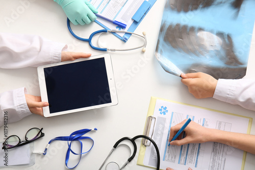Doctor's hands with tablet,...