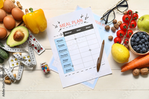 Blank meal plan and health food on table photo