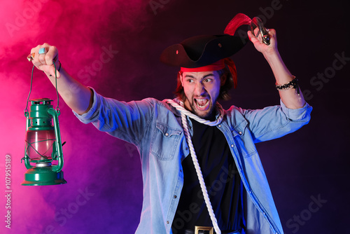 Aggressive pirate with lantern and saber on dark background photo