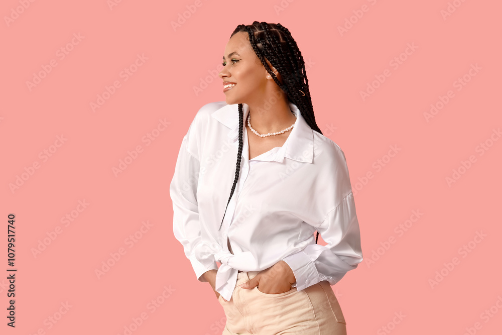 Stylish young African-American woman with braids on pink background Stylish young African-American woman with braids on pink background