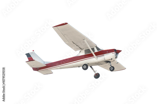 Light Aircraft fly by. A small and red airplane zooms by on a isolated white background. A two seater propeller plane with fixed gear and high wings. Popular flight training plane