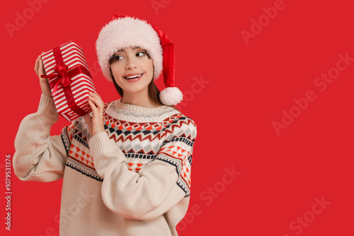 Young woman with Santa hat ...