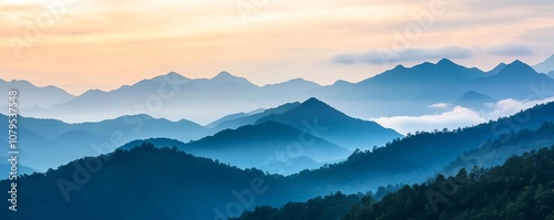 Misty mountain landscape at dawn, sunlight diffused by clouds, serene and majestic, soft natural light