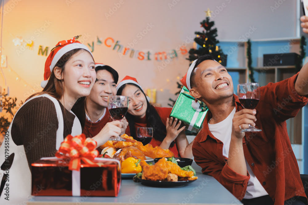 Group of young Asian man and women as friends having fun at a New Year's celebration, holding gift boxes standing by Christmas tree decoration, midnight countdown Party at home with holiday season. Group of young Asian man and women as friends having fun at a New Year's celebration, holding gift boxes standing by Christmas tree decoration, midnight countdown Party at home with holiday season.