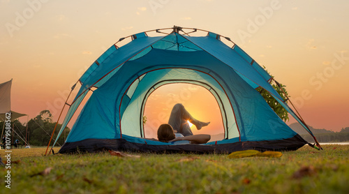 Woman lay draw in camping tent surrounding scenery enjoying nature emphasizing the beauty of nature and the simplicity of camping holidays life concept. photo