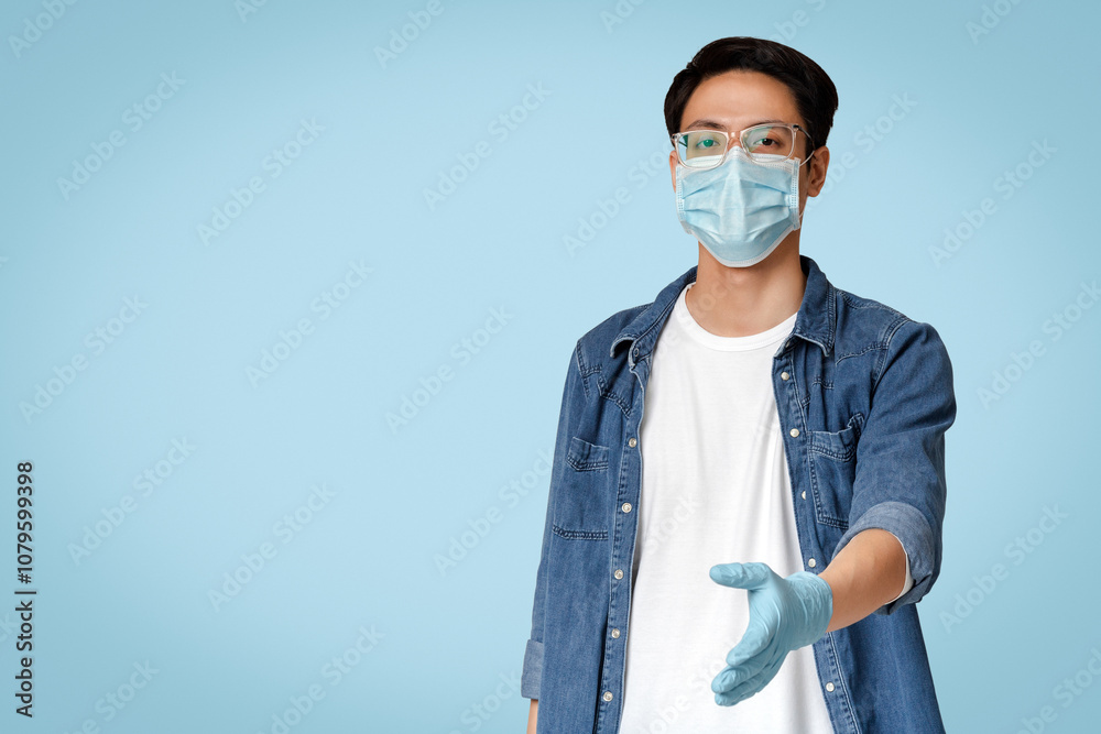Young Chinese Guy In Medical Mask And Gloves Giving Hand For Handshake At Camera, Standing On Light Background In Studio, Copy Space Young Chinese Guy In Medical Mask And Gloves Giving Hand For Handshake At Camera, Standing On Light Background In Studio, Copy Space