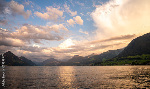 Mountain in the Alps in summer, panoramic view with mountain. Switzerland Alps nature and travel. Alpine scenery. Mountain with lake in Alps. Summer view over the lake and the alps in Switzerland.