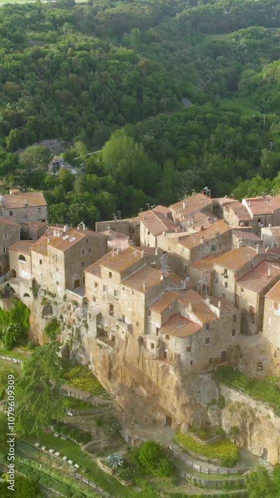Aerial vertical view of Pitigliano town, located atop a volcanic tufa ridge, known as the little Jerusalem. Etruscan heritage, Grosseto, Tuscany, Italy. Aerial vertical view of Pitigliano town, located atop a volcanic tufa ridge, known as the little Jerusalem. Etruscan heritage, Grosseto, Tuscany, Italy.