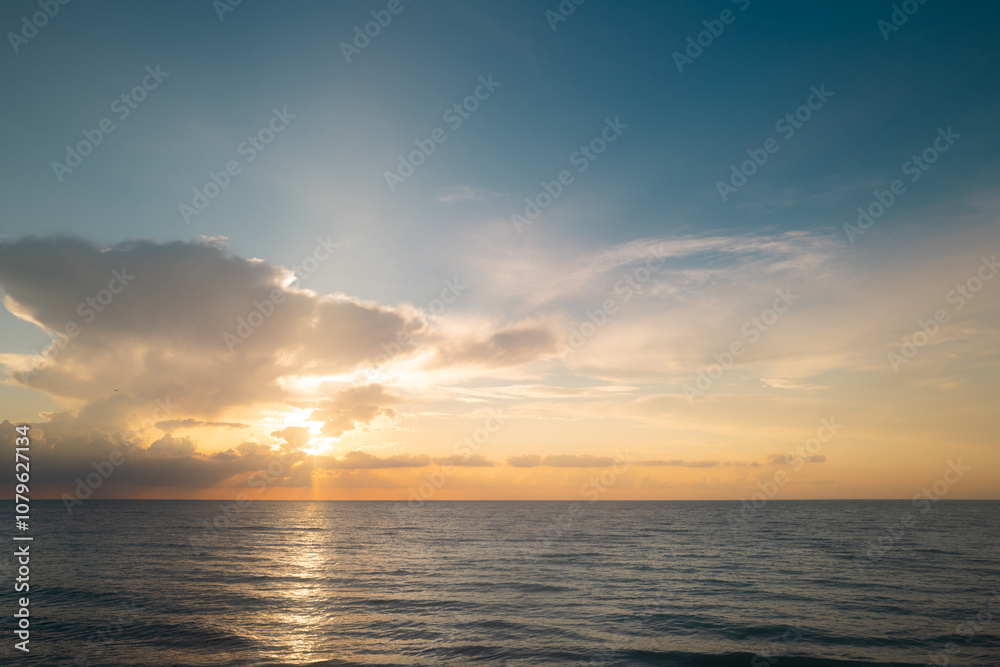 Sea sunset with cloudy sky and sun through the clouds over. Clouds Ocean and sky background, seascape. Sea sunset with cloudy sky and sun through the clouds over. Clouds Ocean and sky background, seascape.