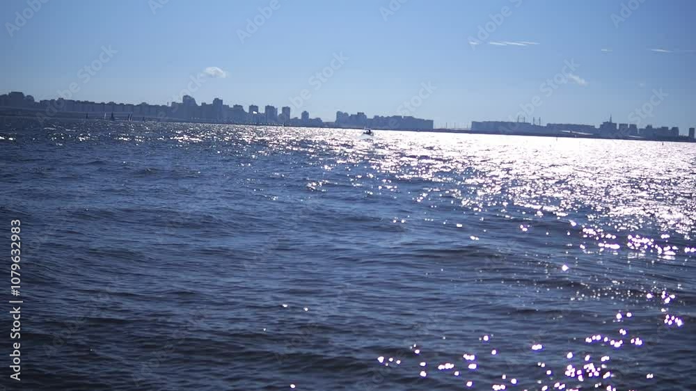 a breathtaking and shimmering ocean landscape extending under a bright blue sky overhead a breathtaking and shimmering ocean landscape extending under a bright blue sky overhead