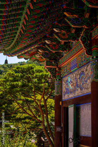 Wall of Korean temple with painting and colorful eaves