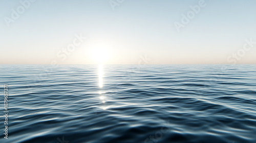 A calm blue ocean with a bright sun shining in the distance, creating a glistening reflection on the water.