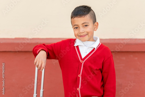 Portrait of young student dressed in uniform on the street