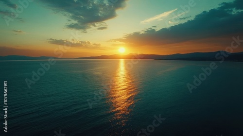 A serene sunset over calm waters, reflecting vibrant colors and creating a tranquil atmosphere.