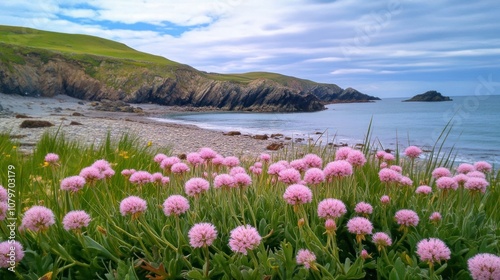 A serene coastal scene featuring pink flowers in the foreground and a rocky shoreline in the background.