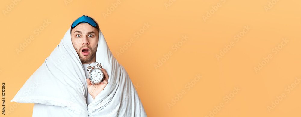 Young man does not want get up for work on yellow background Young man does not want get up for work on yellow background