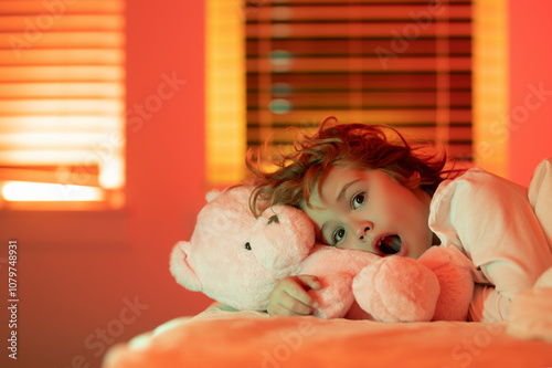 Nightmare for children. Child enjoys night sllep. Kid asleep. Sleepy child in bed. Little child in bed. photo