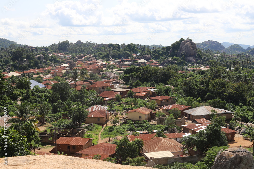 Aerial view of a Africa village nestled amidst lush greenery with red-roofed houses and rocky hills in the background, showcasing a serene and natural landscape. Aerial view of a Africa village nestled amidst lush greenery with red-roofed houses and rocky hills in the background, showcasing a serene and natural landscape.